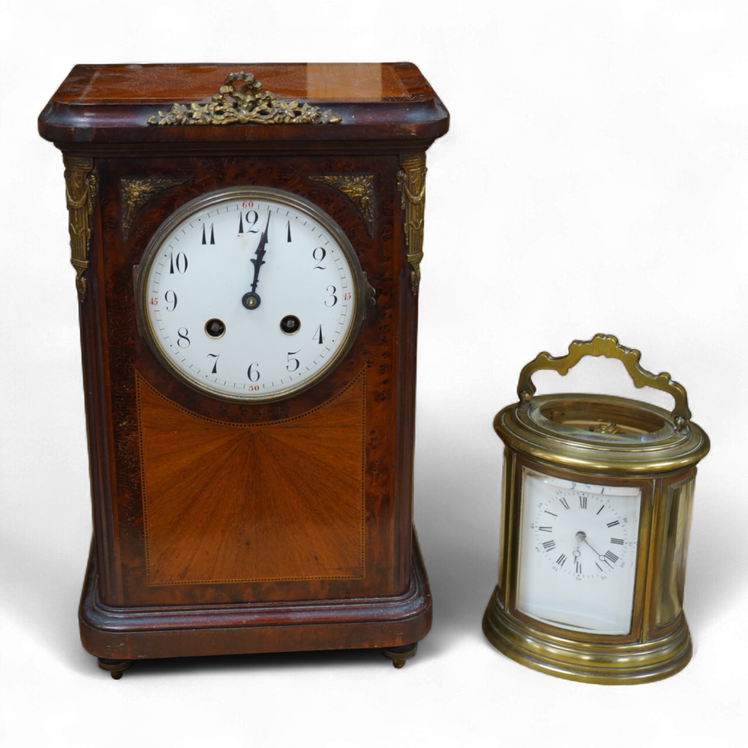 A 19th century oval brass carriage clock, striking on a bell, together with a mahogany and burr yew mantel clock, striking on a coiled gong, gong missing, largest 34cm high